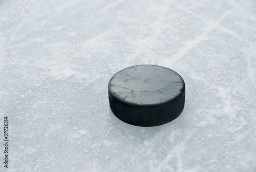 Photo: hockey puck on ice hockey puck on ice