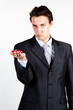 portrait of a young manager for motor with a small red toy car