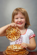 little girl eats pancakes