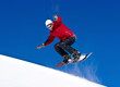 Snowboarder jumping through air with deep blue sky
