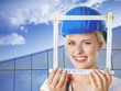 Young female builder takes measurements for housebuilding
