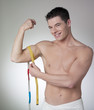 Photo: man measuring his biceps man measuring his biceps