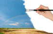 The hand with a brush draws a landscape.