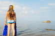The girl on seacoast looks in a distance The girl on seacoast looks in a distance