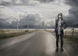 Photo: Young woman alone standing on road Young woman alone standing on road