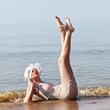Photo: Woman in white hat posing against the sea Woman in white hat posing against the sea