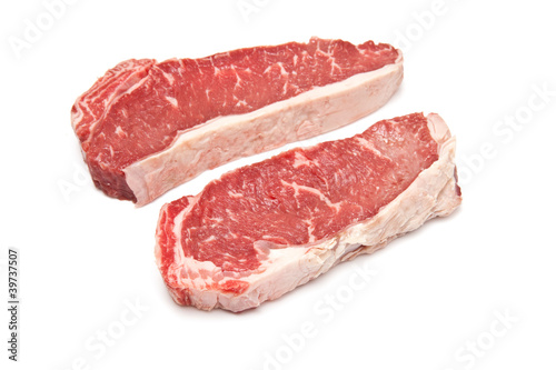 Photo: Sirloin steaks (beef) on a white studio background. Sirloin steaks (beef) on a white studio background.
