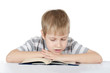 The boy reads the book isolated on white