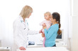 Photo: Young mother with baby visiting pediatric doctor Young mother with baby visiting pediatric doctor