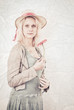 Vintage portrait of a blonde woman holding a flower