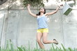 Happy woman jumping with shopping bags