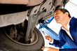 Mechanic working under a car