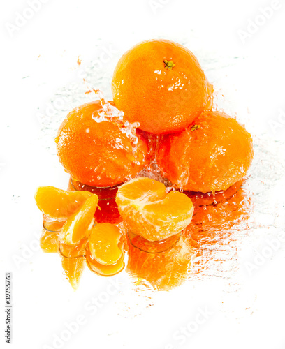 Photo: several tangerines in water splash several tangerines in water splash