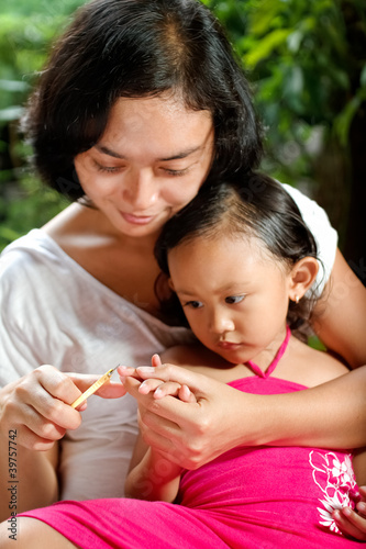 Photo: ethnic mother manicure child fingernail ethnic mother manicure child fingernail
