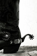 Old-fashioned western still life with old cowboy shoes ans spurs