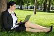 Businesswoman working laptop in the park