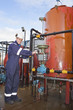Petrochemical contractor posingl in front of an oil refinery