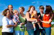 Family and multi-generation - fun on meadow in summer