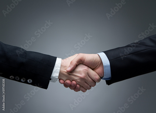 Photo: Man and woman business handshake Man and woman business handshake