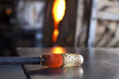 Glass blower shaping molten glass
