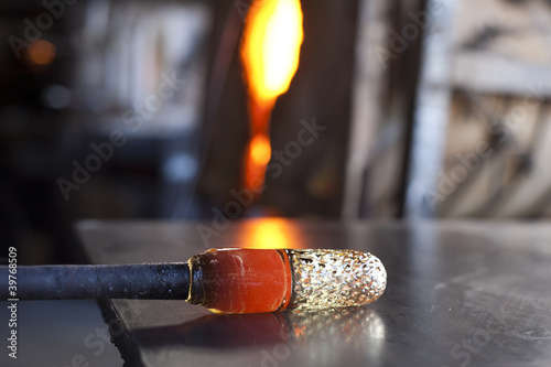 Photo: Glass blower shaping molten glass Glass blower shaping molten glass