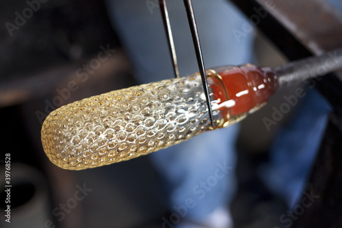 Photo: Glass blower shaping molten glass Glass blower shaping molten glass