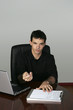business guy offering pen to sign paperwork