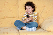 Beautiful child with the remote control of television
