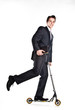 successful man in business suit who rides a scooter