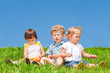 Babies sit on grass