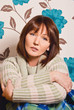 woman of forty years sitting on the couch wrapped in a blanket woman of forty years sitting on the couch wrapped in a blanket