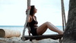 girl on the swing by the sea