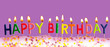 Happy birthday lit candles on purple background