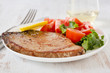 fried tuna with salad and lemon on the plate