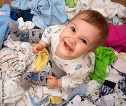Photo: Baby in heap of wear Baby in heap of wear
