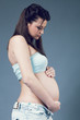 Beautiful pregnant white woman wearing blue shirt Beautiful pregnant white woman wearing blue shirt