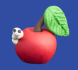 White worm and a red apple