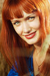 Young pretty woman with red hair at the field of wheat Young pretty woman with red hair at the field of wheat
