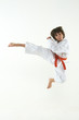boy practicing karate on white background