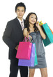 Shopping couple smiling. Isolated over white background