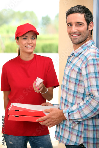 Photo: Woman delivering pizza Woman delivering pizza
