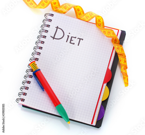 Photo: Planning of diet. Notebook measuring tape and pencil isolated Planning of diet. Notebook measuring tape and pencil isolated