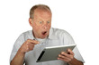 Astonished man looking at his tablet computer