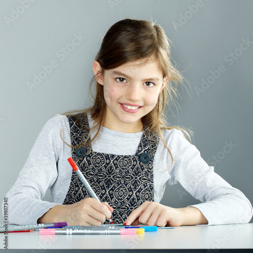 Photo: Sweet little child is painting a colourful picture Sweet little child is painting a colourful picture