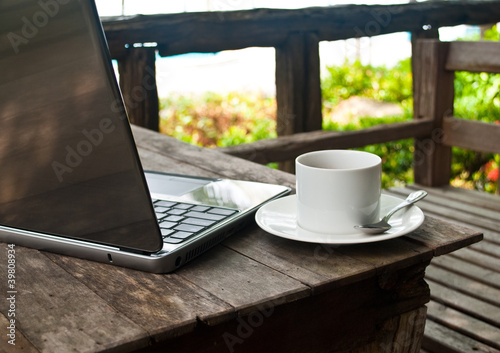 Photo: Coffee cup and laptop for business. Coffee cup and laptop for business.