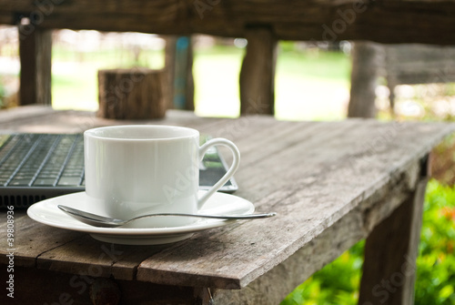 Photo: Coffee cup and laptop for business. Coffee cup and laptop for business.