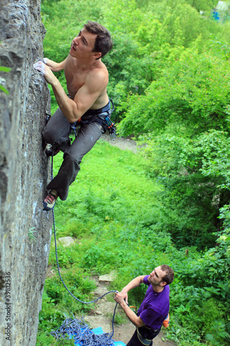 Photo: Rock climbers, the leader climbing up, the other belaying Rock climbers, the leader climbing up, the other belaying