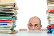 Man staring nervously at piles of folders