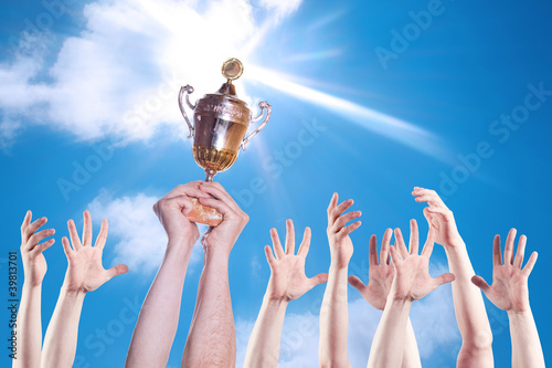 Photo: Hand of the person with a sports cup Hand of the person with a sports cup