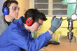 Photo: Young man using a bench drill Young man using a bench drill
